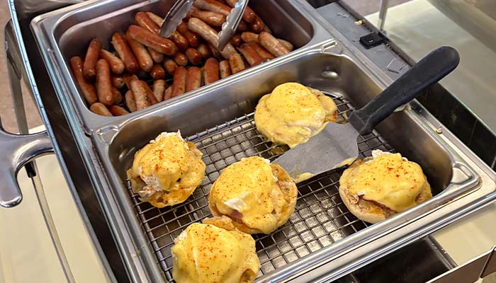 Sausages and eggs Benedict with hollandaise sauce at Montrose Minnesota Bar & Grill buffet.