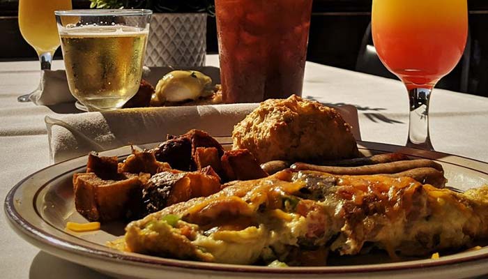 A Montrose Minnesota breakfast at Jacque B's Kitchen & Cocktails with omelet, biscuit, and drink.